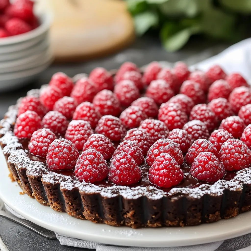 A slice of chocolate cake with raspberries on top.