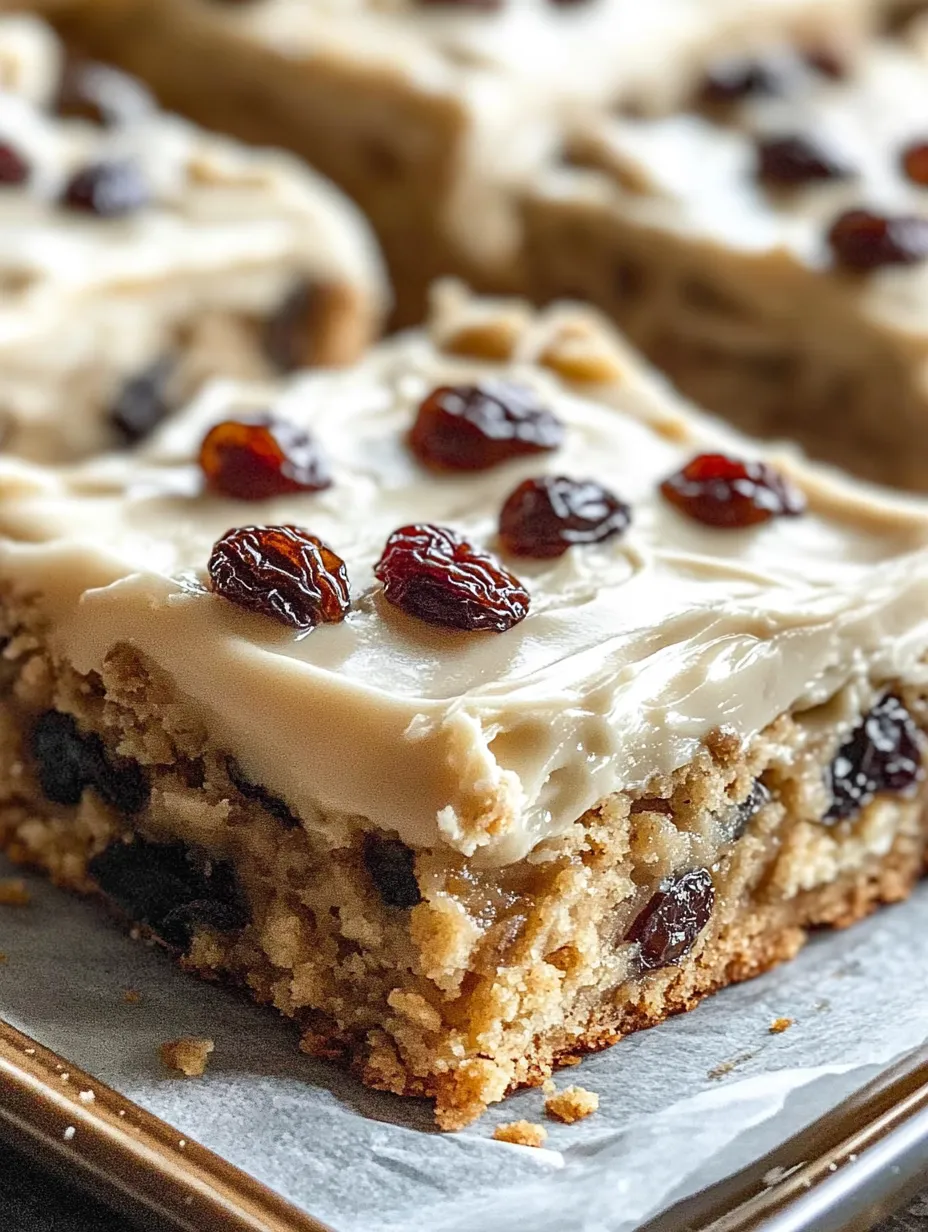 A slice of cake with raisins on top.