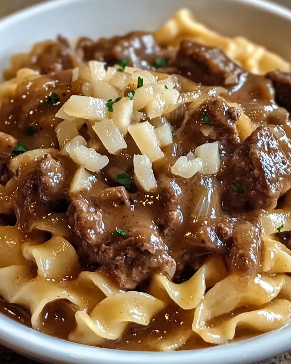 A bowl of pasta with meat sauce.