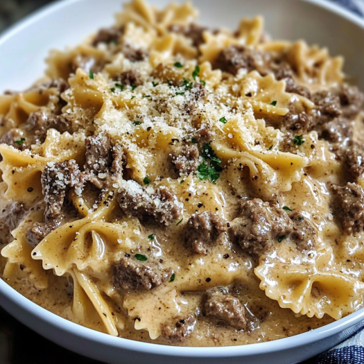 A bowl of creamy Parmesan garlic beef bowtie pasta.