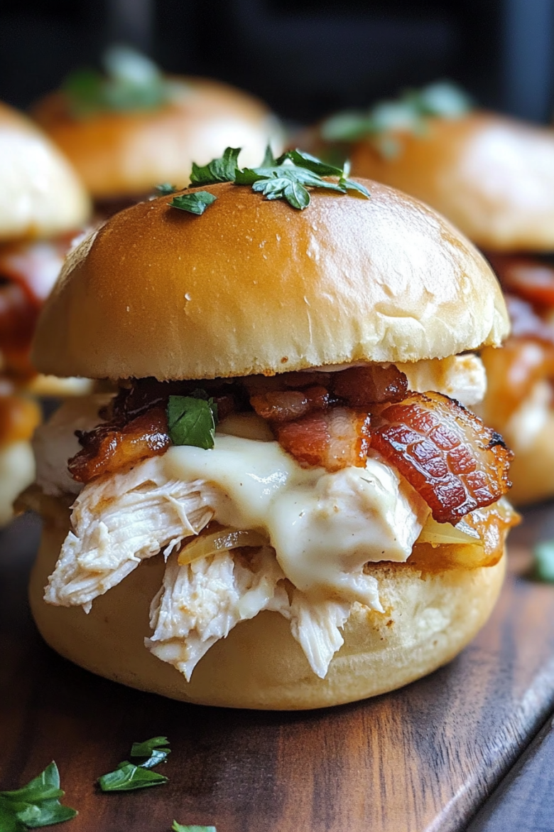 A chicken bacon ranch slider with cheese and bacon on top.