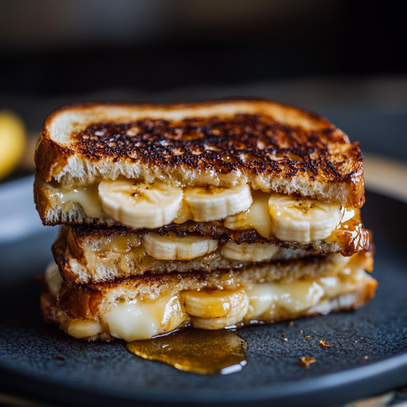 A grilled cheese sandwich with bananas on top.