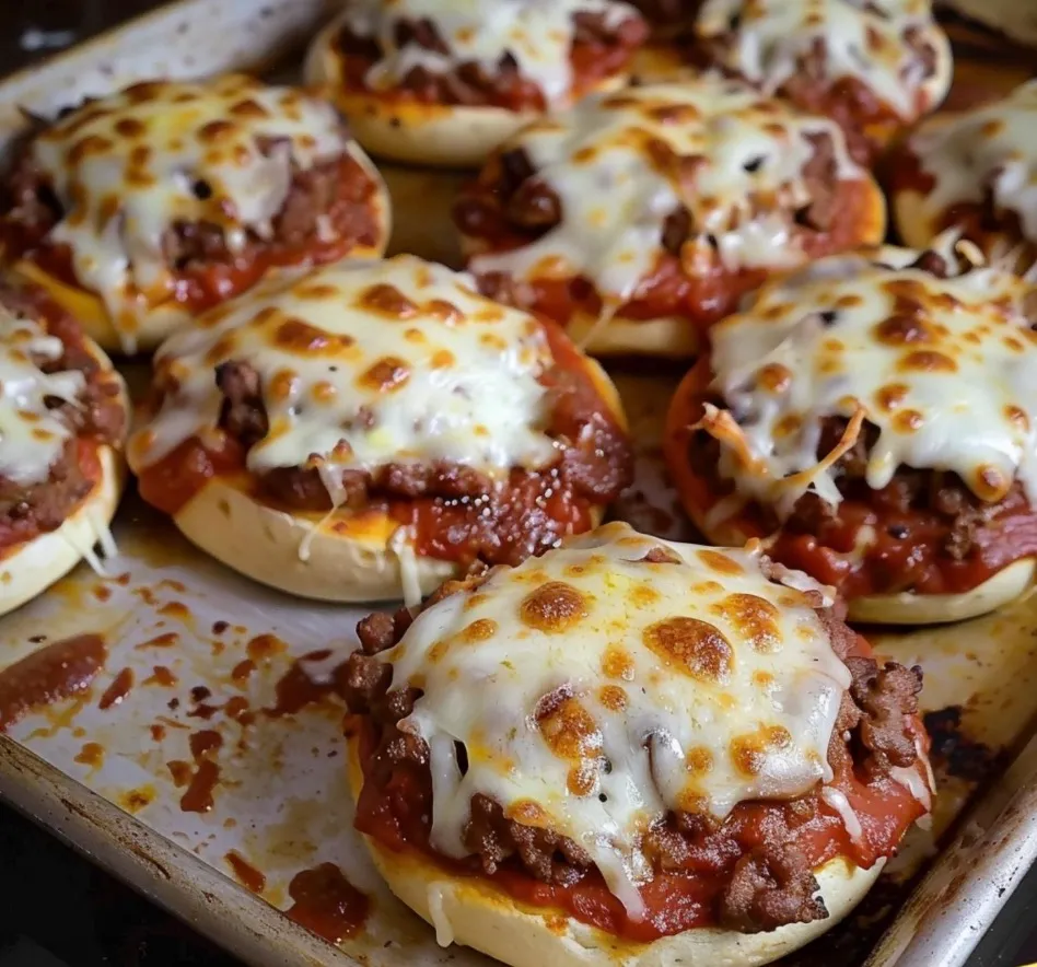 A tray of cheesy Italian pizza burgers.