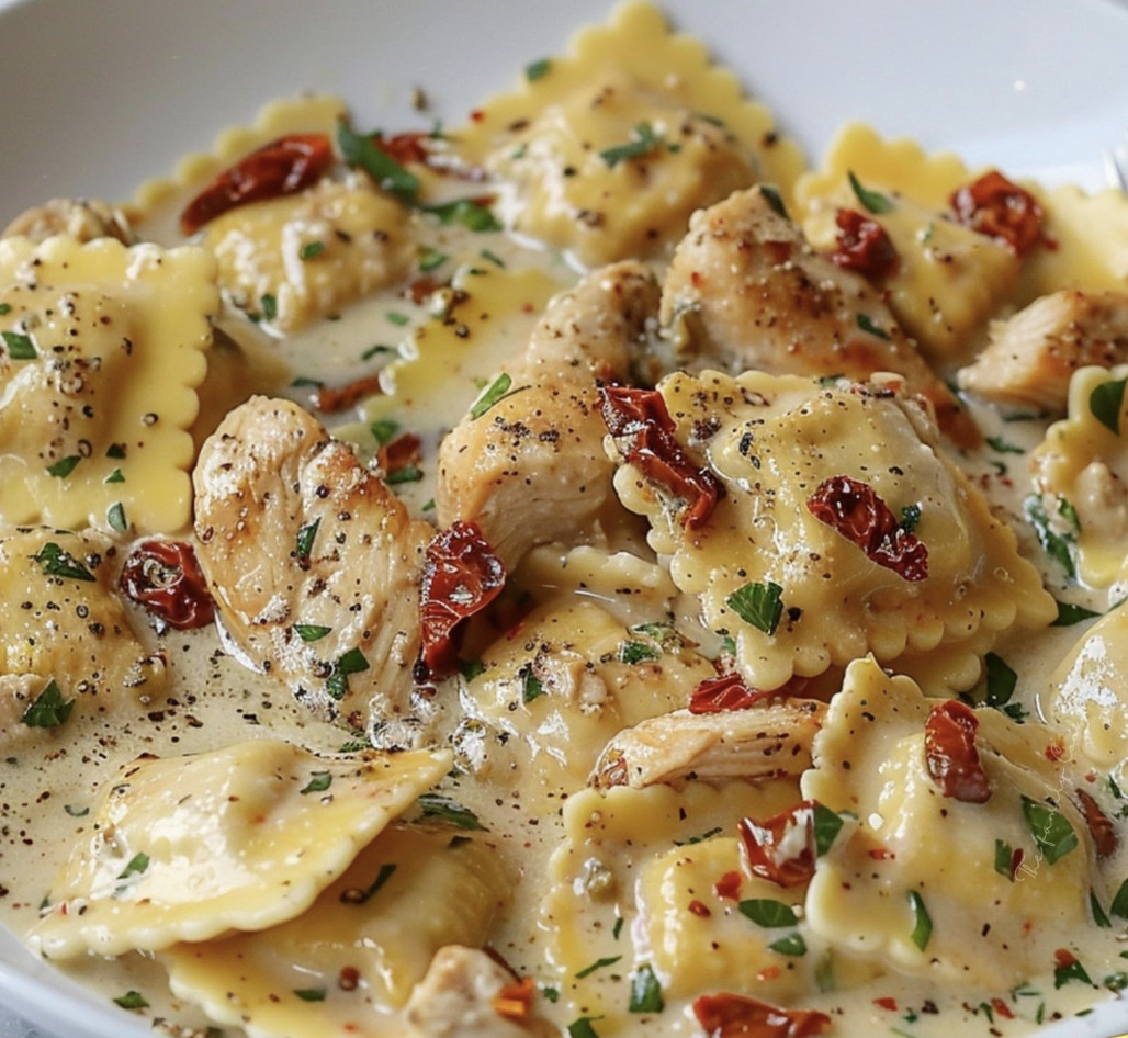 A bowl of pasta with chicken and red peppers.