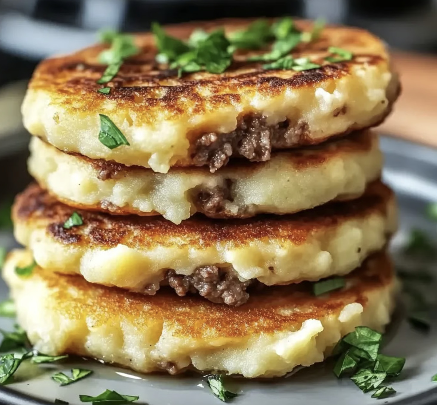 A stack of mashed potato pancakes with beef.