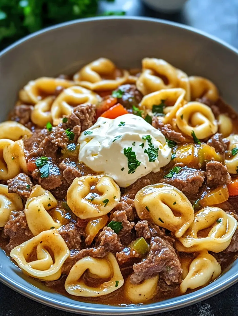 A bowl of cheesesteak, tortellini, and meat.