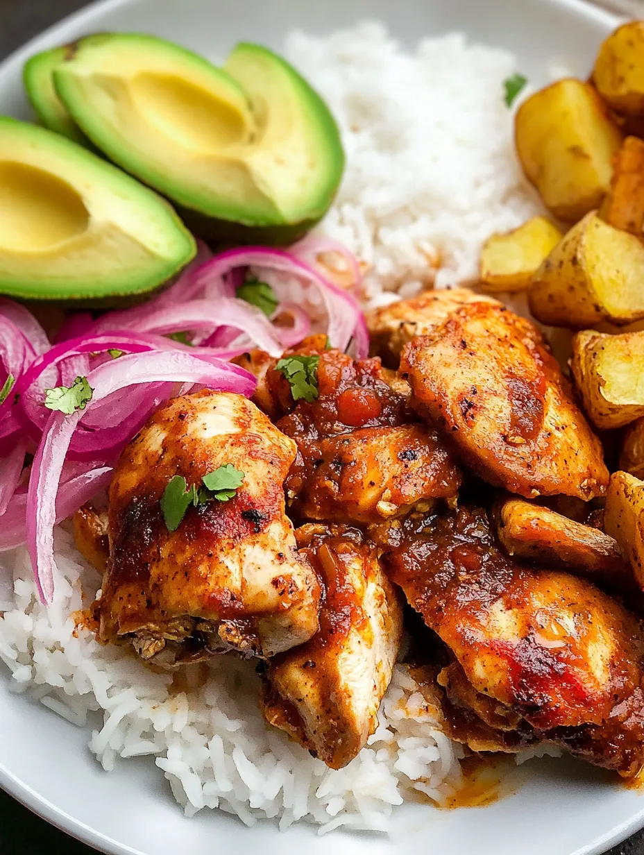 A plate of Mexican Adobo Chicken with rice and avocado.