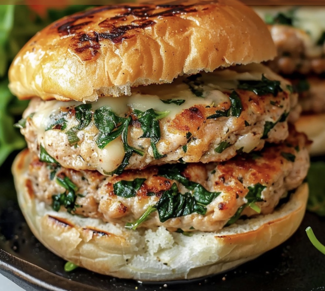 A burger with greens on top.
