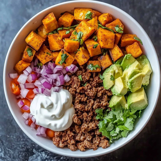 A bowl filled with a delicious Sweet Potato Taco Bowl.