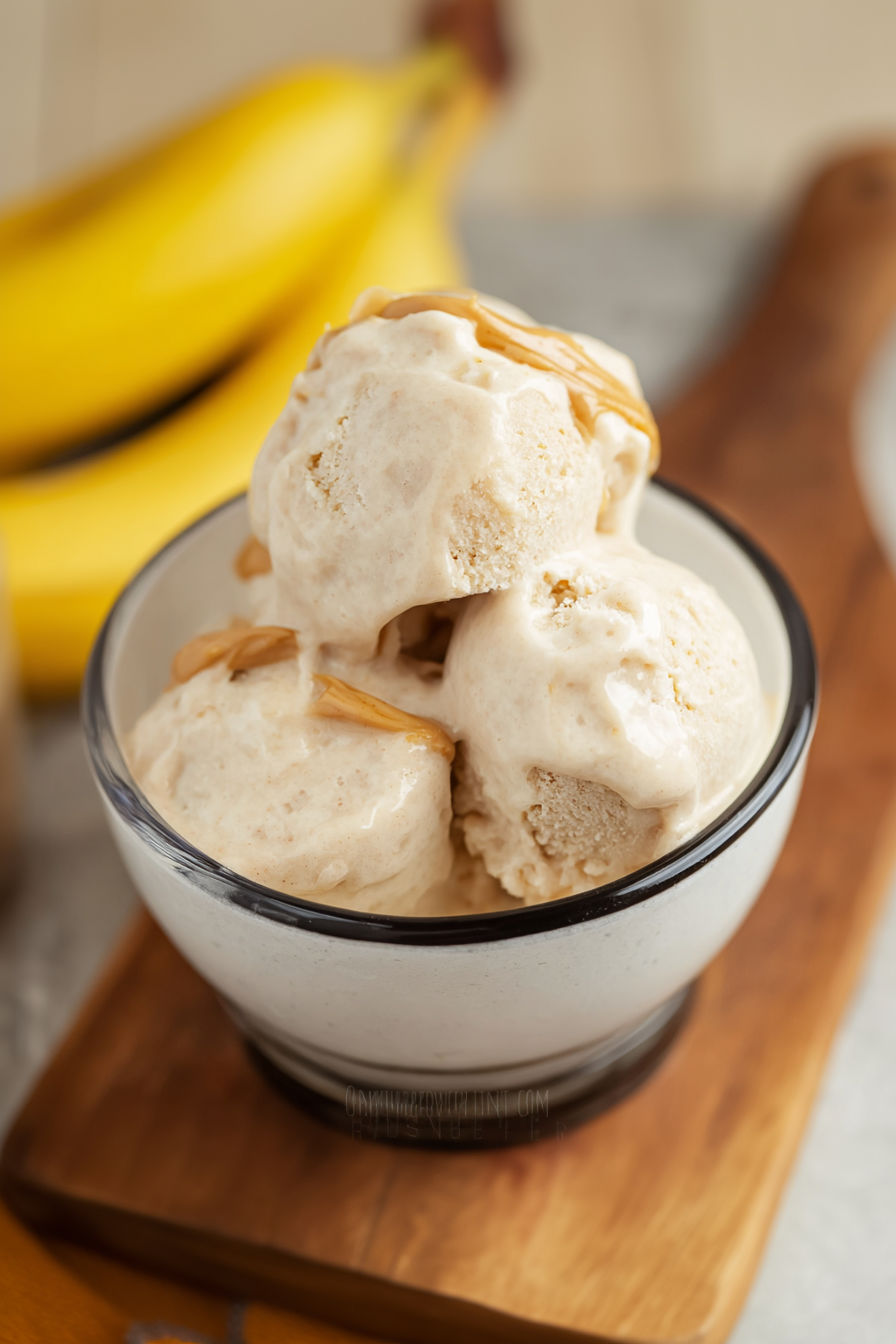 A bowl of dog ice cream with banana slices on top.