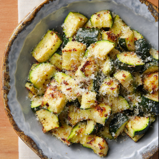 A dish of air fryer zucchini with parmesan cheese, served in a bowl.