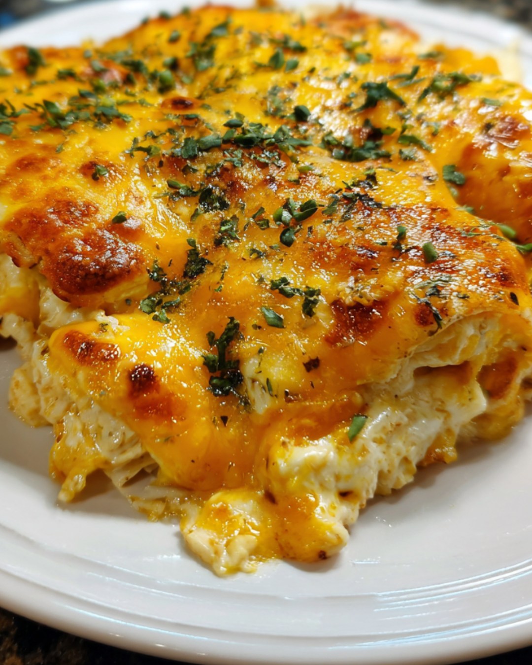 A delicious Baked Chicken Quesadilla is served on a white plate.