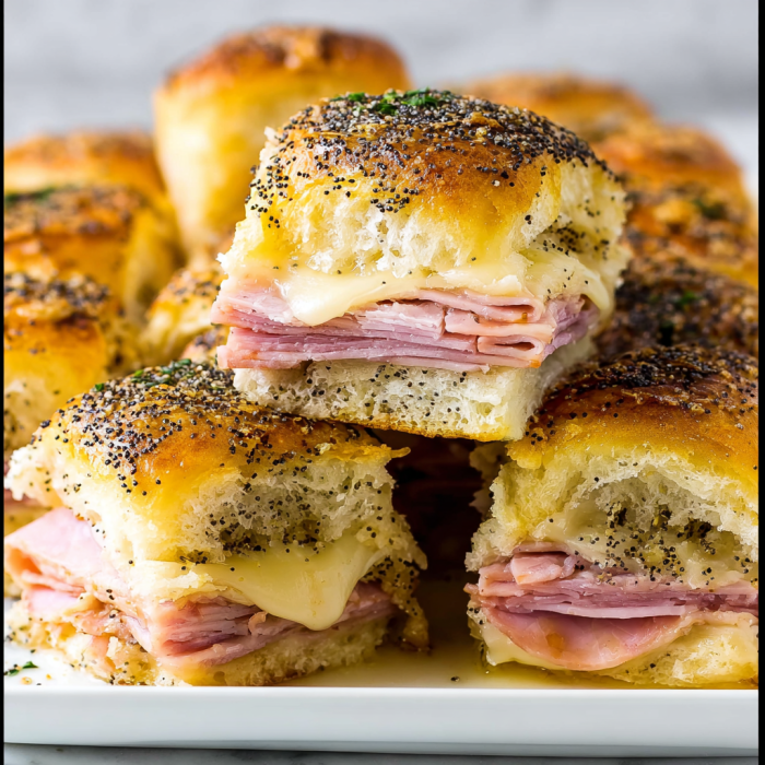 A plate of ham and cheese sliders, with a total of 12 pieces.