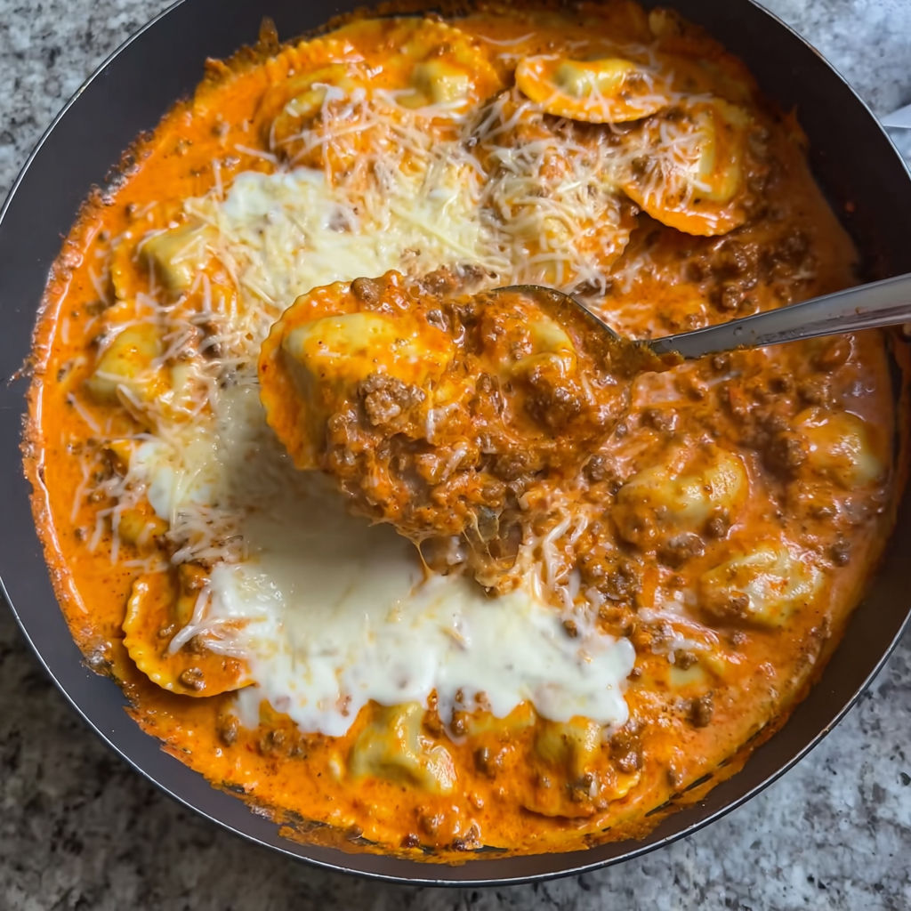 A bowl of Million Dollar Ravioli with a spoon in it.