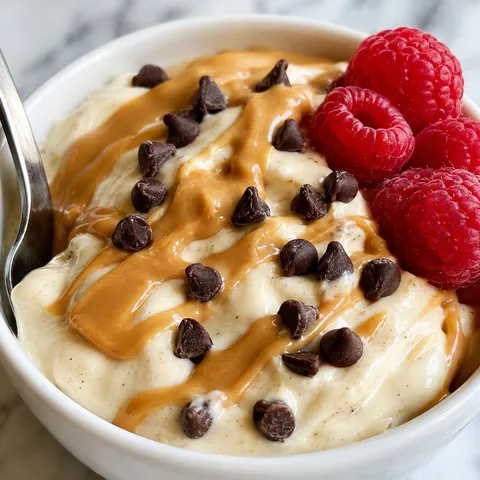 Protein yogurt pudding with peanut butter drizzle and mini chocolate chips