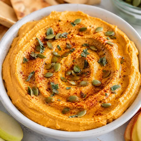 Pumpkin hummus with fresh sage, pepitas, olive oil, and pita chips