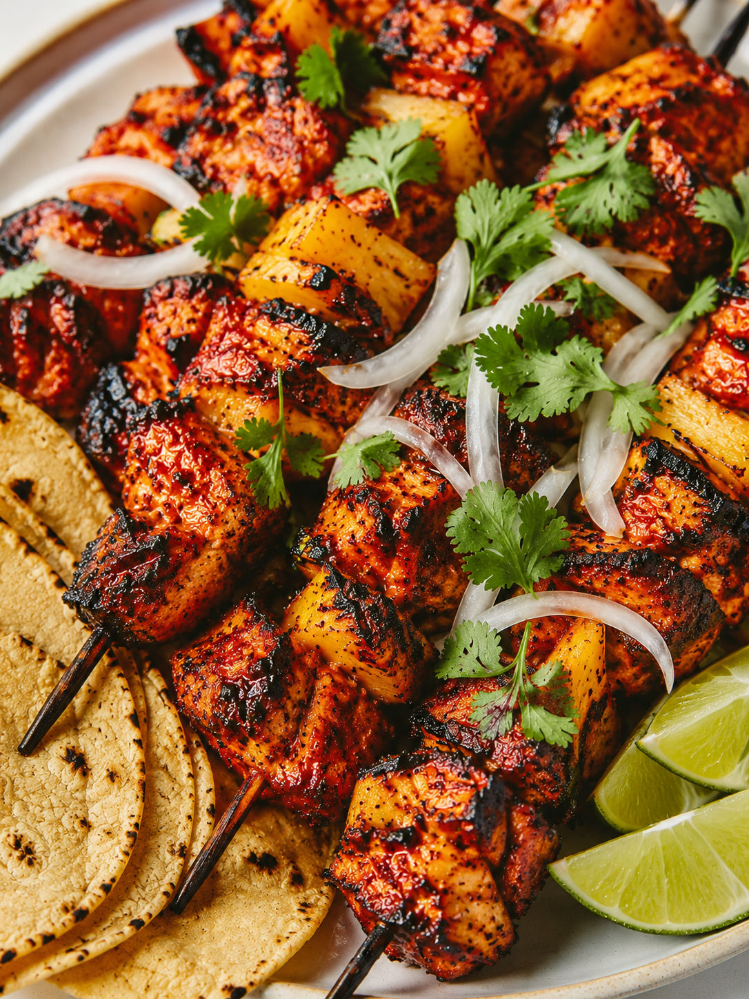 Grilled al pastor chicken skewers with pineapple, cilantro, and lime