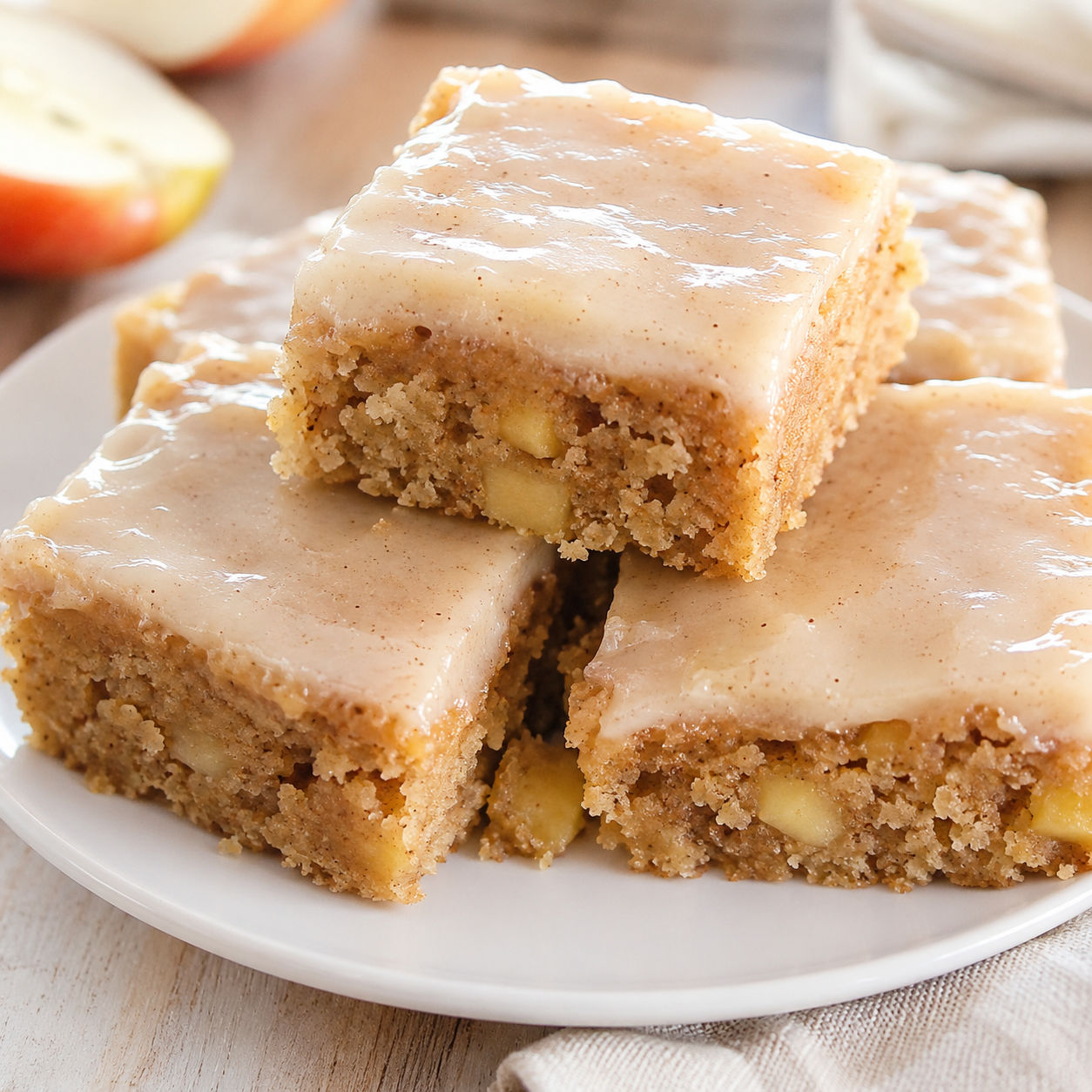 Maple glazed apple brownie squares on a white dessert plate