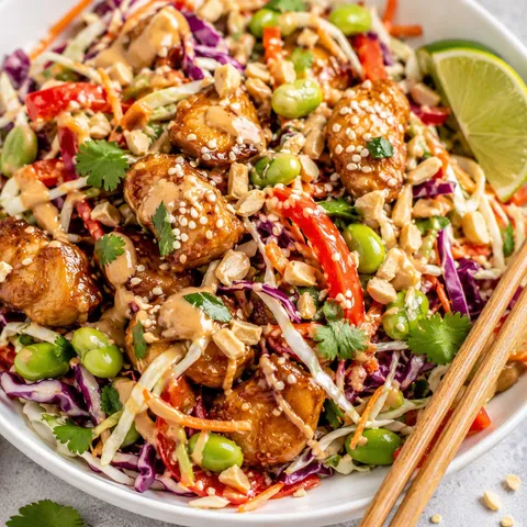 Asian chicken crunch salad with peanut dressing, cabbage, peanuts, and herbs
