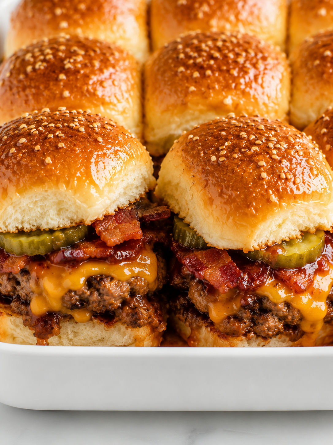 Pull-apart BBQ bacon cheeseburger sliders with melted cheddar