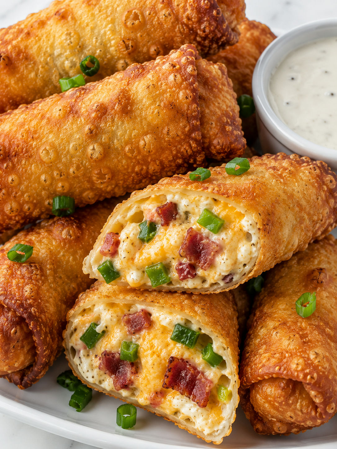 Crispy bacon jalapeño popper eggrolls with melted cheese and ranch
