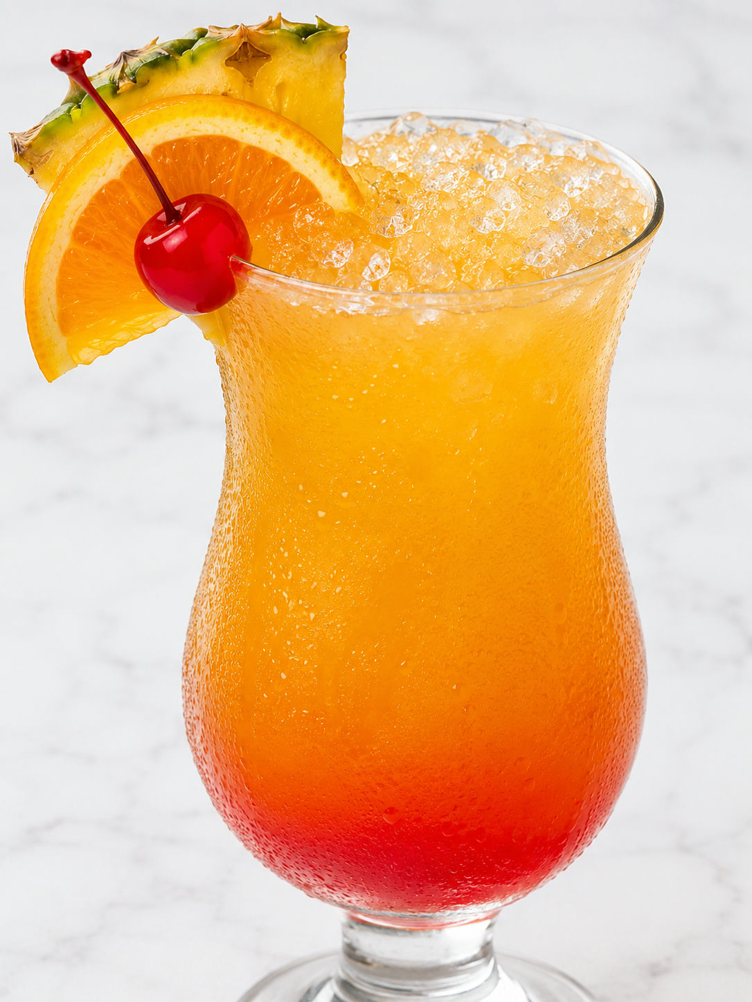 Bahama Mama tropical drink over ice with pineapple and cherry garnish