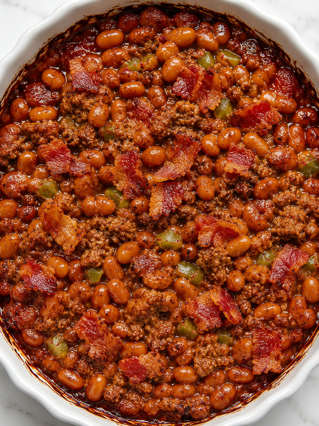 Top-down baked beans and ground beef casserole with crisp bacon
