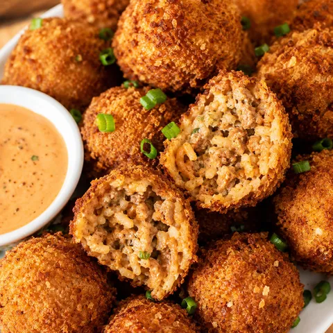 Golden baked boudin balls with creamy Cajun dipping sauce