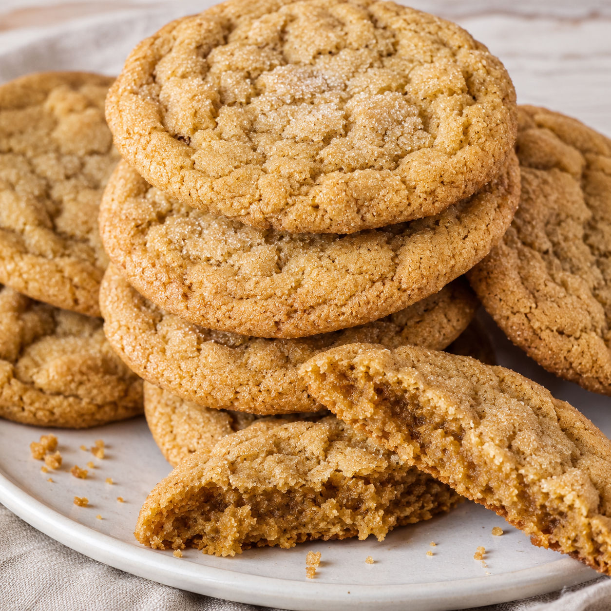 Chewy brown sugar cookies with crackly tops and a broken soft center