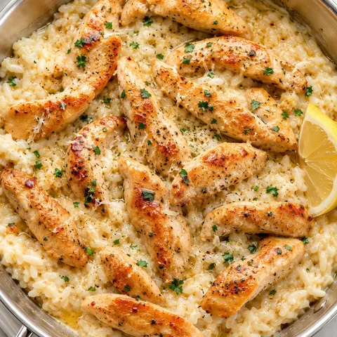 Chicken scampi over creamy garlic Parmesan rice with parsley and lemon