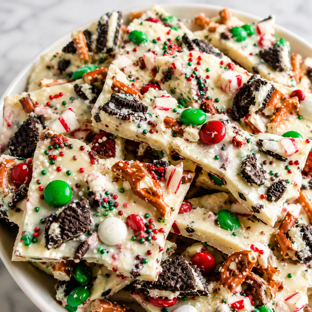 Christmas Bark with white chocolate, pretzels, cookies, peppermint, and red candy
