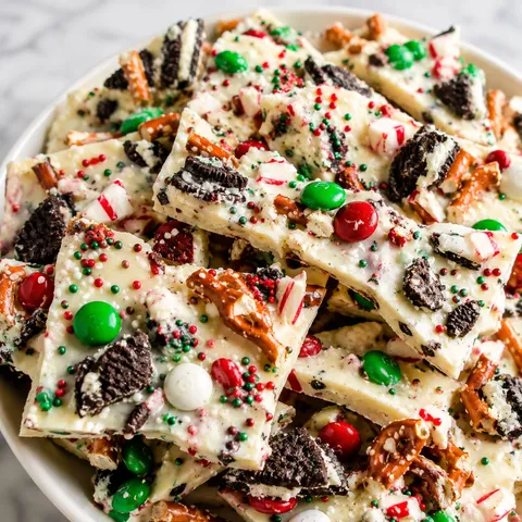 Christmas Bark with white chocolate, pretzels, cookies, peppermint, and red candy