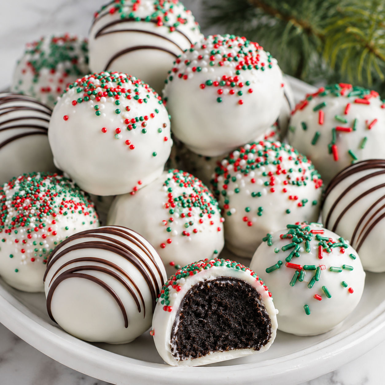 Christmas Oreo Balls with sprinkles and one truffle cut open