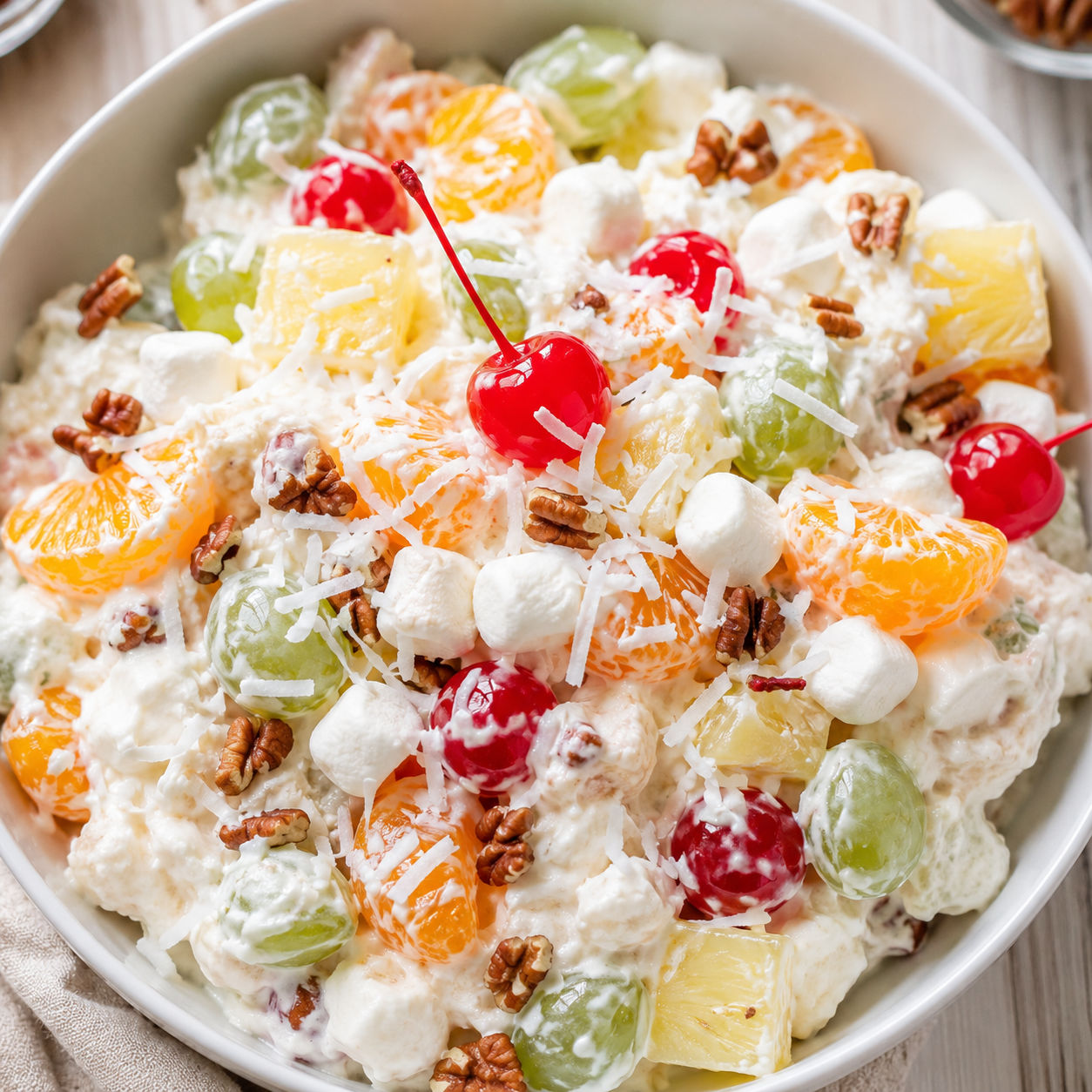 Ambrosia fruit salad with coconut, cherries, mandarins, and marshmallows
