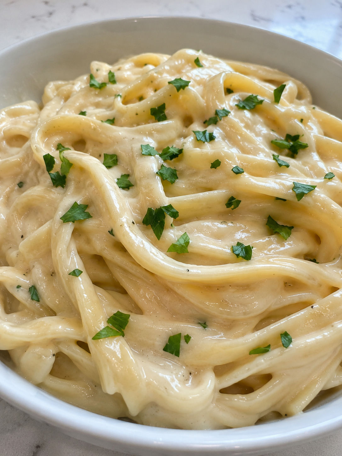 Copycat Olive Garden Alfredo Sauce, plated and served