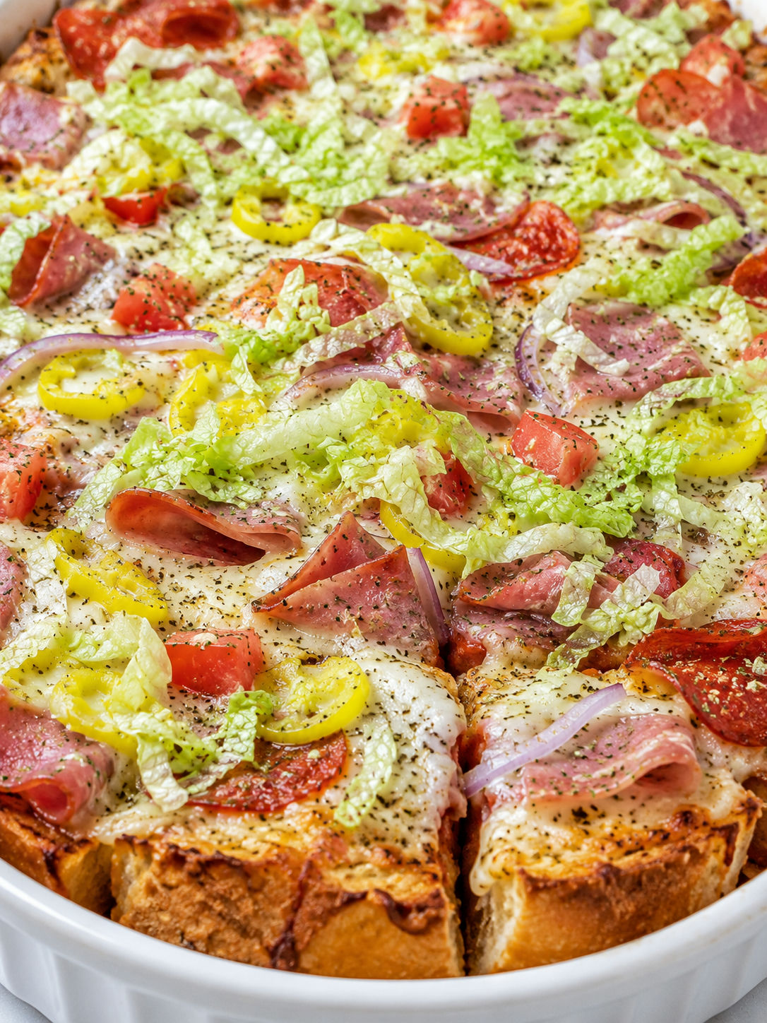 Cheesy Subway BMT casserole slice with pepperoni, salami, vegetables, and lettuce