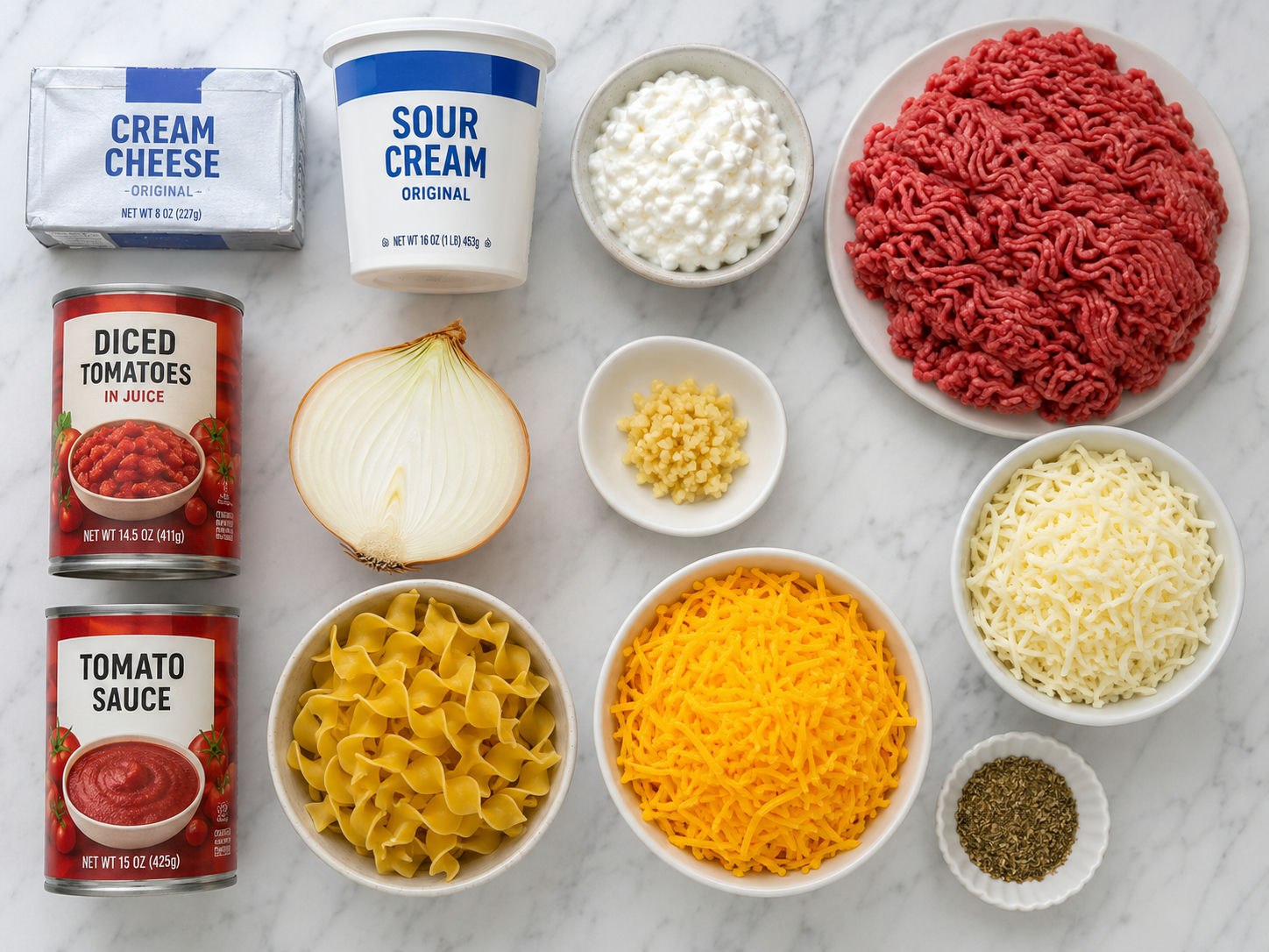 Crazy Good Casserole ingredients including ground beef, cream cheese, egg noodles, and shredded cheddar on marble