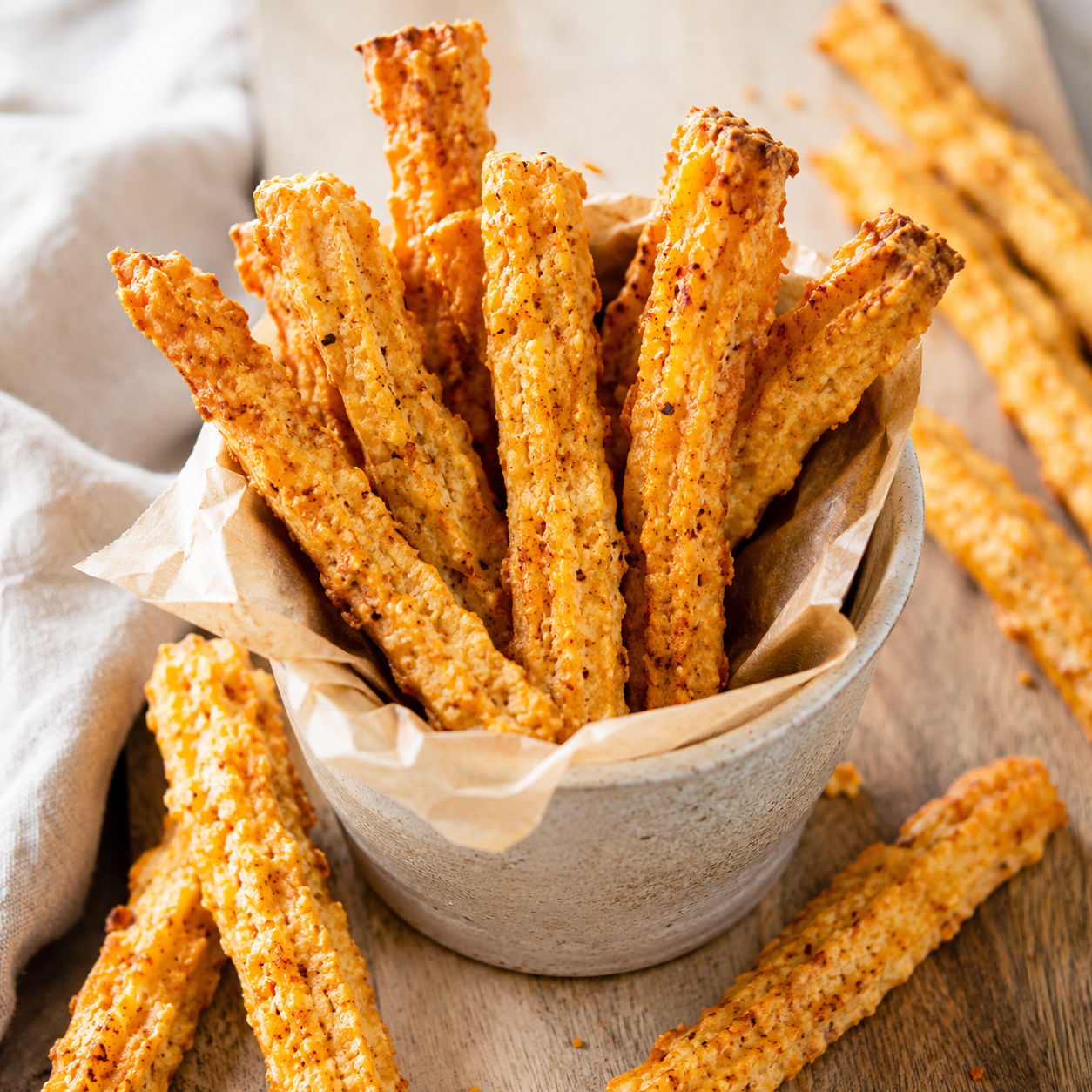 Golden homemade cheese straws with sharp cheddar and paprika flecks