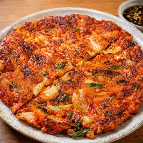 Crispy kimchi pancake with scallions and soy dipping sauce