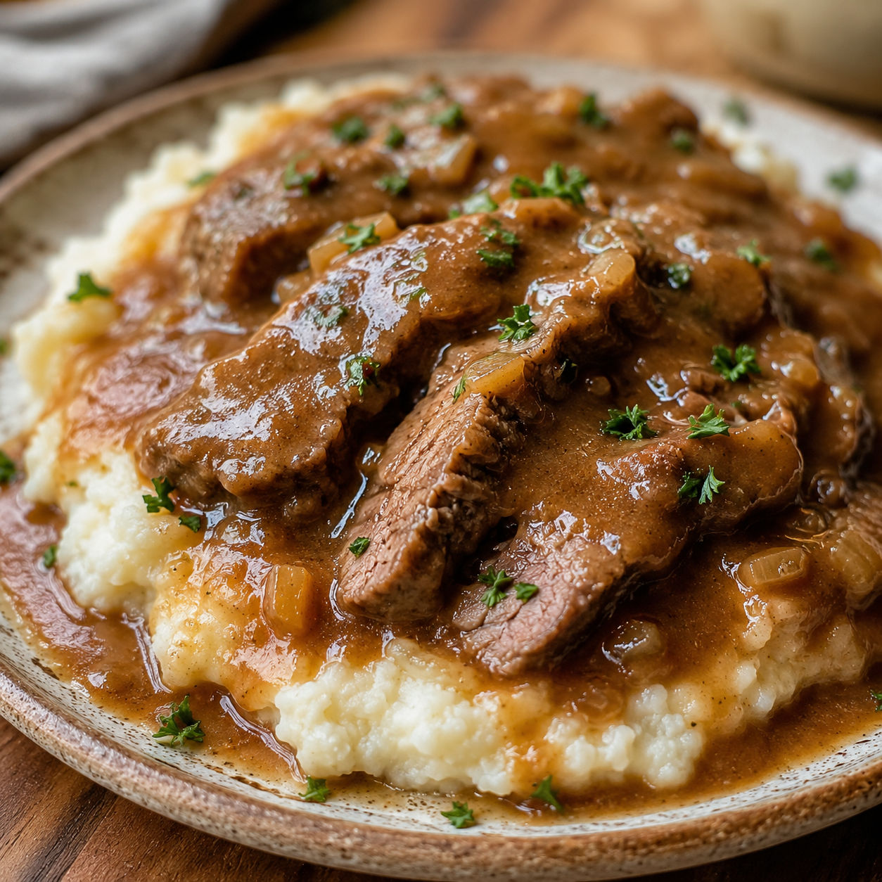 Crock pot cubed steak with brown gravy over mashed potatoes