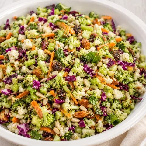 Crunchy Detox Salad with chopped vegetables, almonds, seeds, and raisins