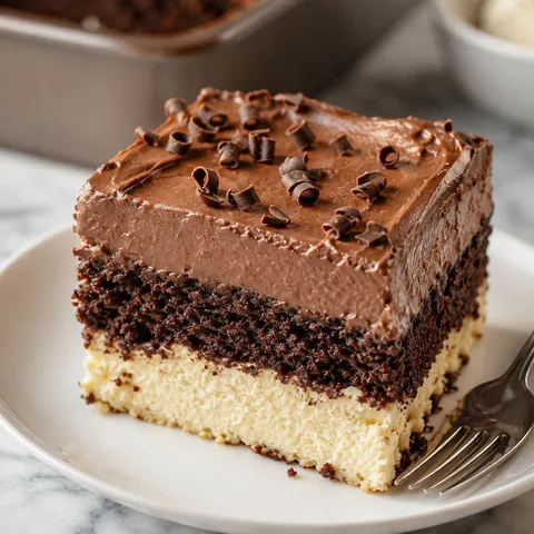 Chocolate ricotta cake slice with pudding frosting and chocolate curls