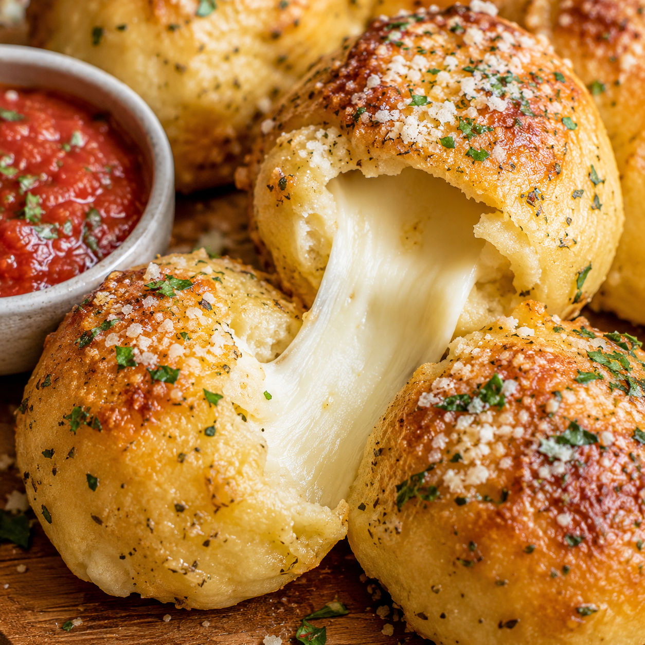Golden cheesy garlic bombs with molten mozzarella and garlic butter glaze