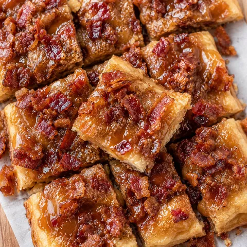 Maple bacon crack with caramelized brown sugar and bacon on parchment