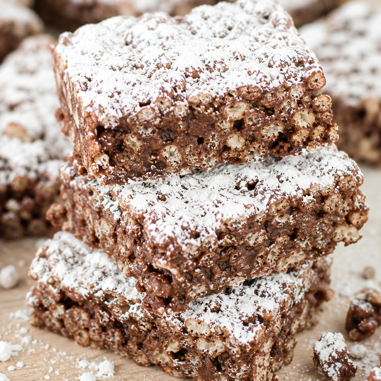 Muddy Buddy Rice Krispies bars dusted with powdered sugar