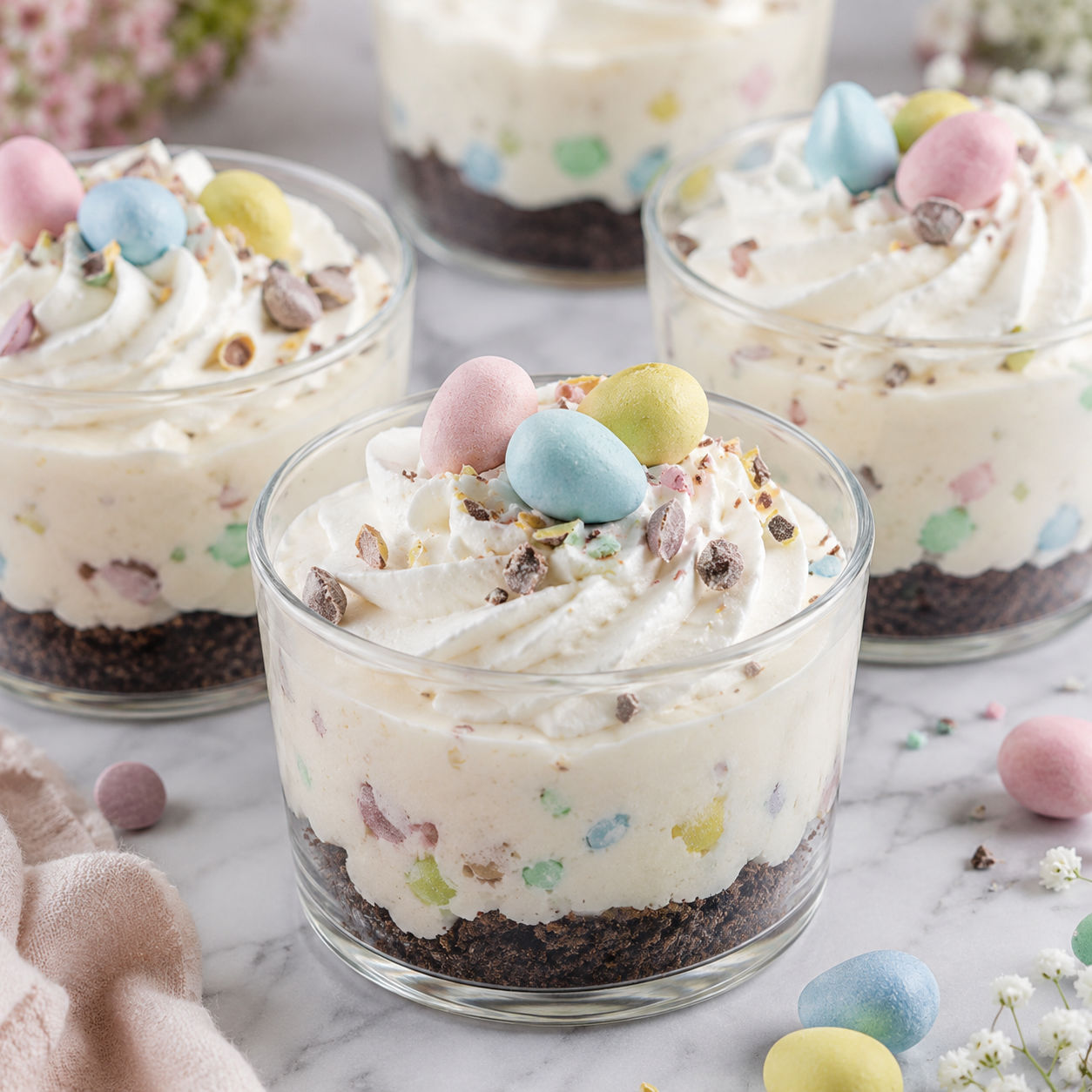 Mini Egg cheesecake cups with cookie crumbs and whipped cream