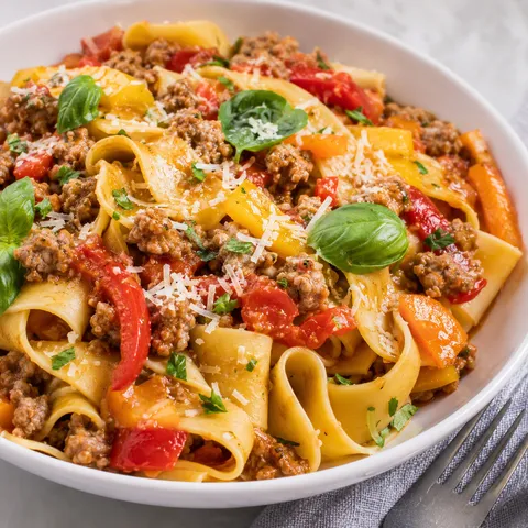 Dreamy Italian drunken noodles with sausage, peppers, basil, and parmesan
