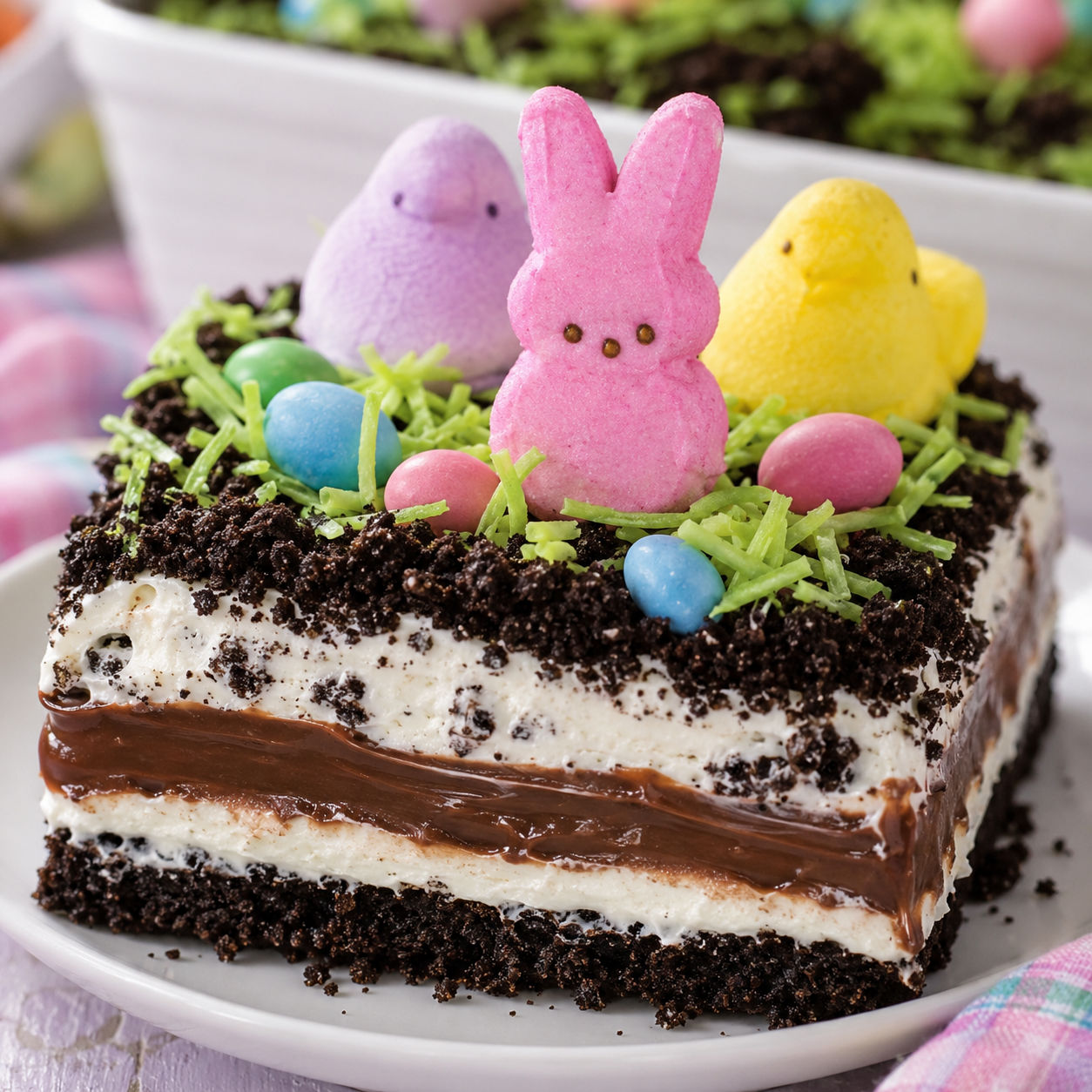 Easter dirt cake with Oreo crumbs, candy eggs, and marshmallow bunnies
