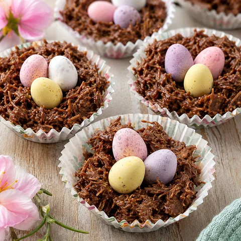 Chocolate Easter nests with pastel mini eggs in paper cases