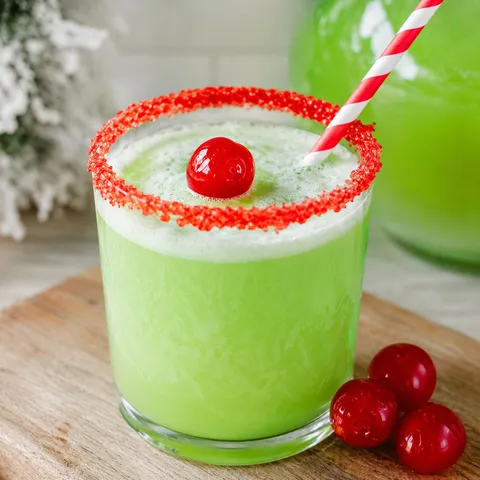 Green Grinch punch with red sugar rim and cherry